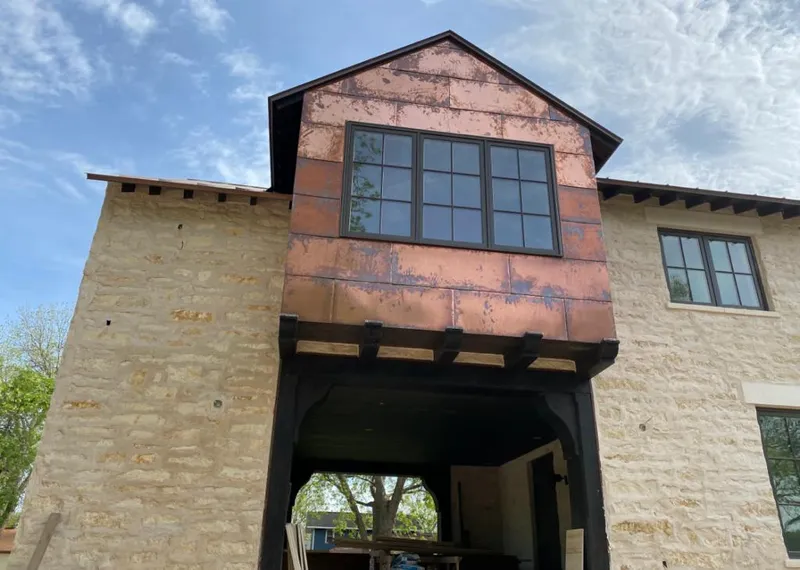 Copper metal panel facade on a stone building for Skylight Installation in Pensacola