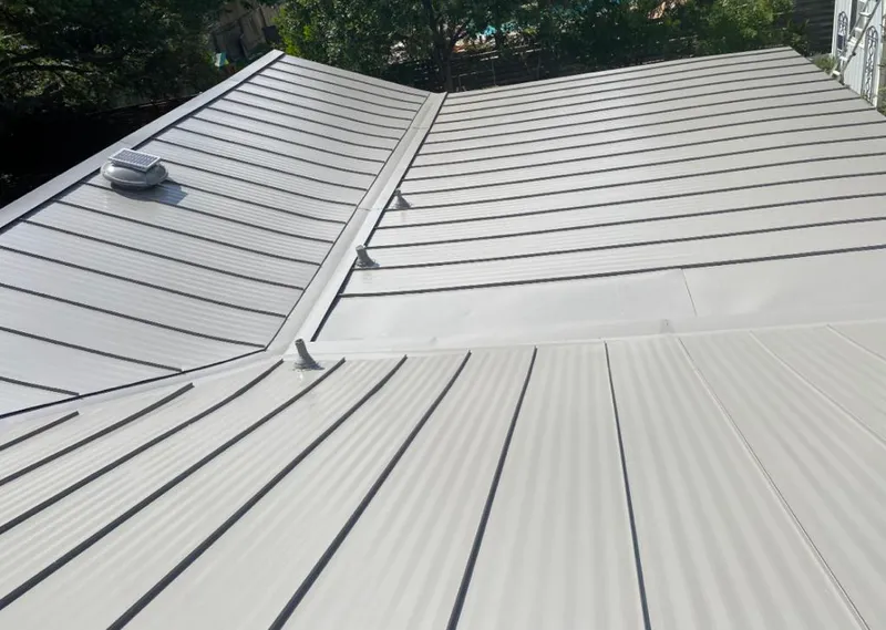 Solar attic fan installed on a metal roof for Roof Ventilation in Pensacola